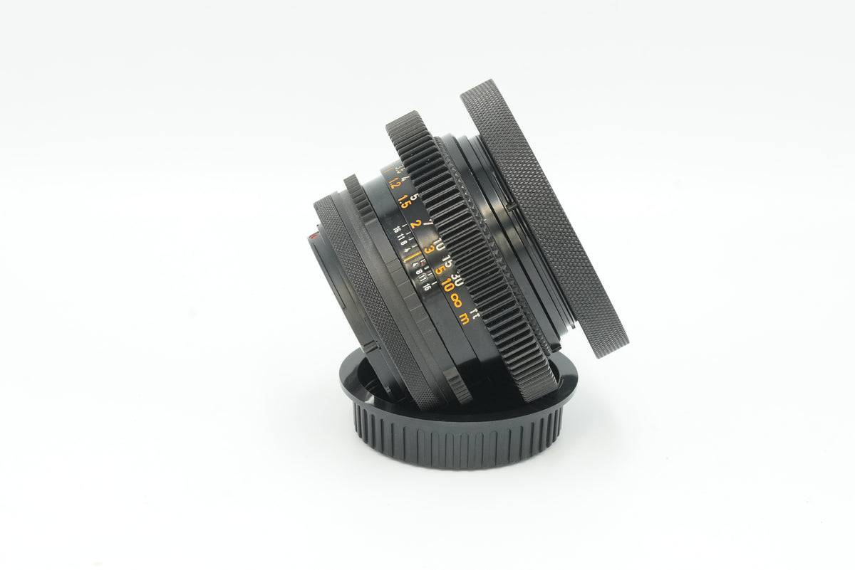 Canon FD 50mm f/1.4 S.S.C. cine mod, side view with focus gear and slip-on cap
