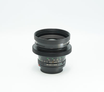 Canon nFD 20mm f/2.8 cine-modded with focus gear and metal hood