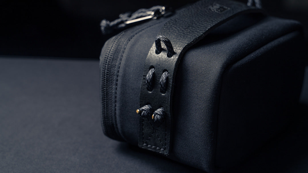 Wotancraft black canvas pouch leather tab and paracord loops close-up