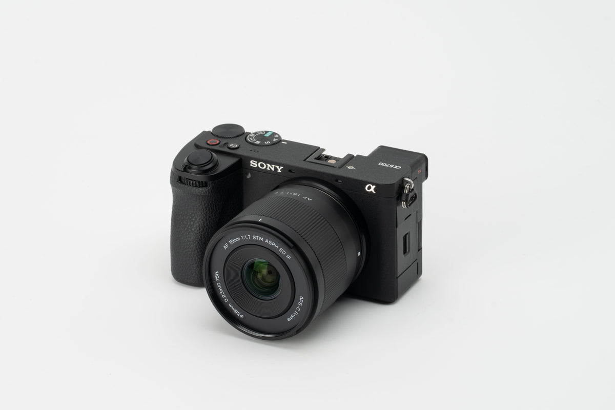 Viltrox Air AF 15mm f/1.7 mounted on a Sony A6700, on a grey background