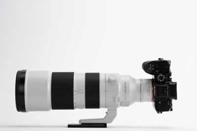 Sony camera with Viltrox 2.0x teleconverter and 200-600mm lens on a tripod foot, side view