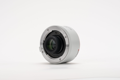 Viltrox 2.0x teleconverter, front angle on a grey background