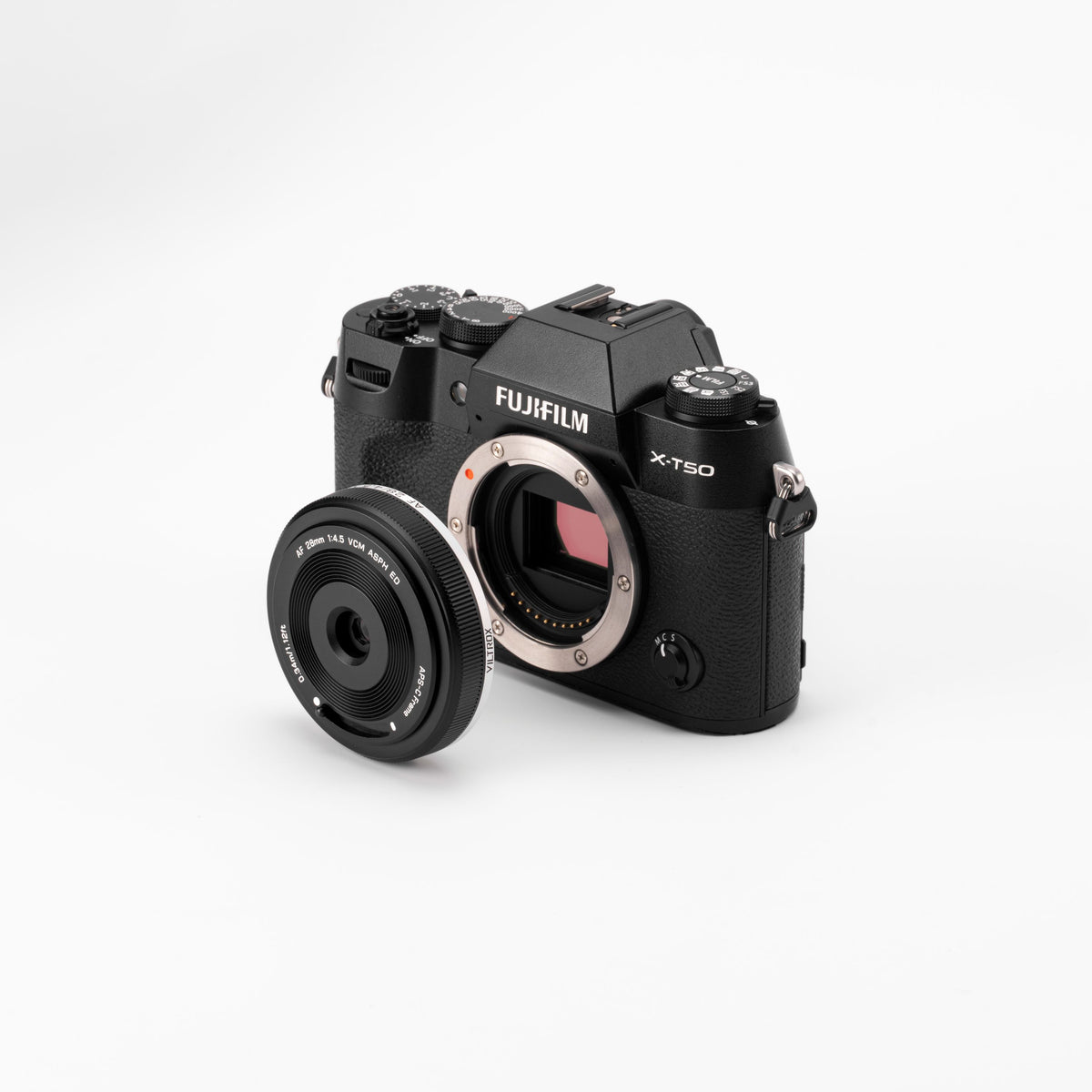 Viltrox AF 28mm f/4.5 XF pancake next to a black Fujifilm X-T50 body