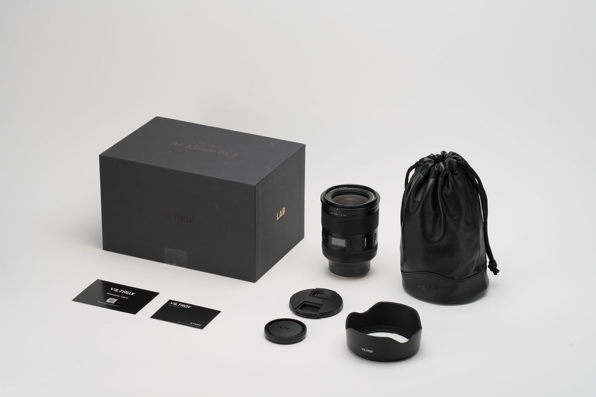 Viltrox LAB AF 35mm f/1.2 box contents: lens, hood, leather pouch, caps and cards