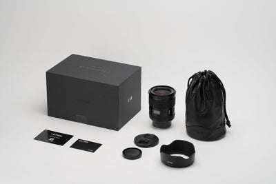 Viltrox LAB AF 35mm f/1.2 box contents: lens, hood, leather pouch, caps and cards