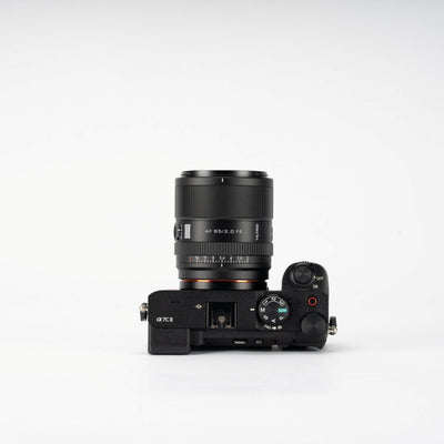 Viltrox AF 85mm f/2.0 FE on a Sony A7C II, top view on grey