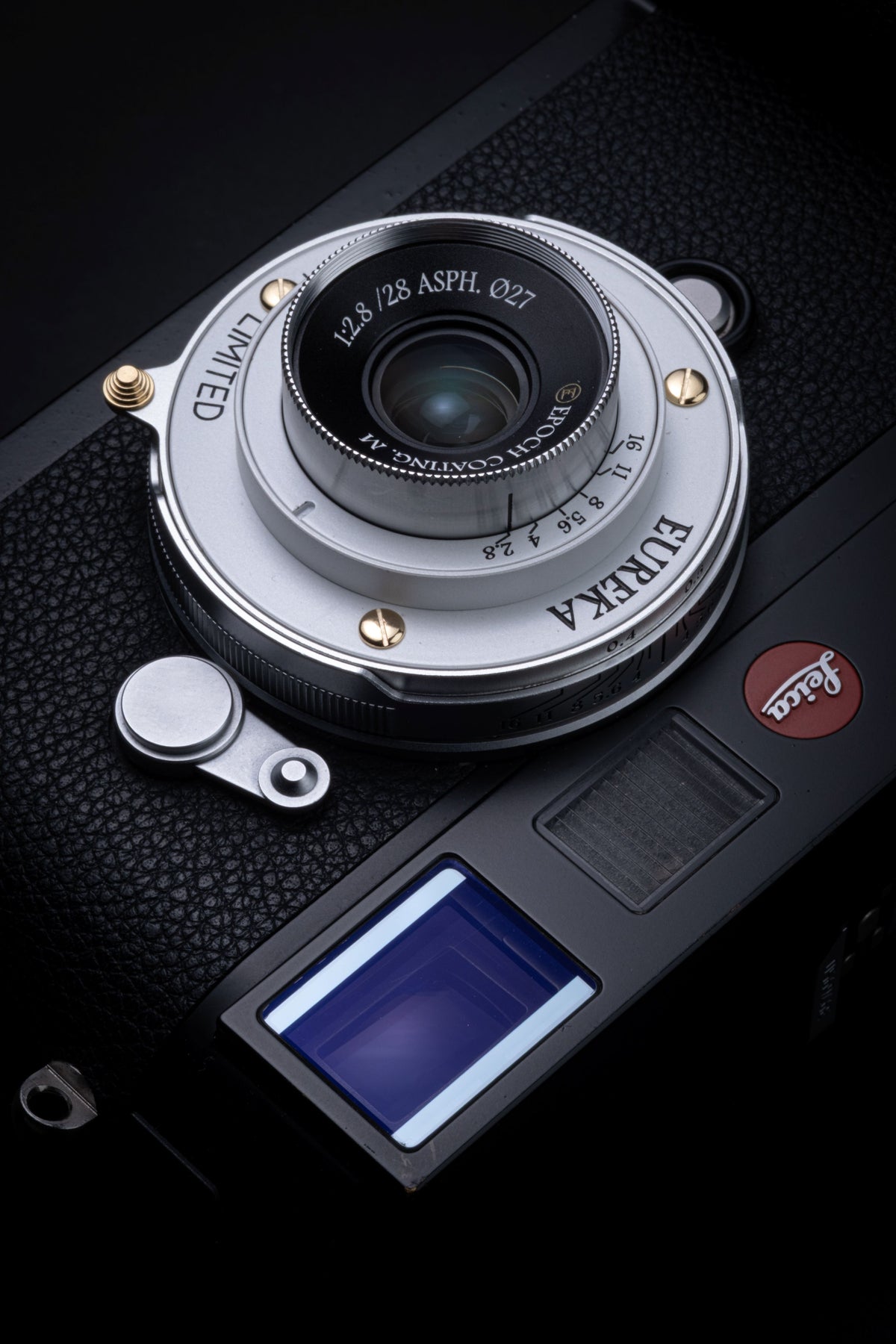 Thypoch Eureka 28mm f/2.8 silver pancake lens mounted on a Leica M camera, top view
