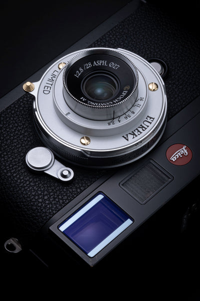 Thypoch Eureka 28mm f/2.8 silver pancake lens mounted on a Leica M camera, top view