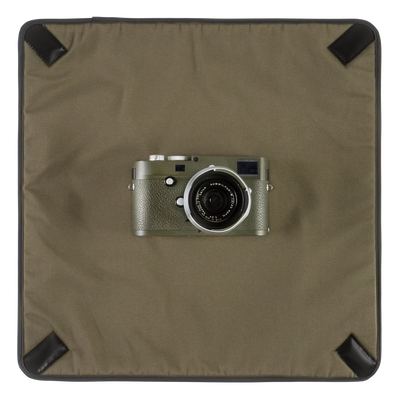 Wotancraft Magician Wrap laid flat with an olive Leica M camera