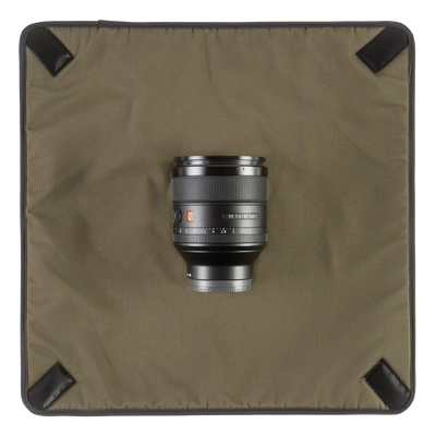 Wotancraft Magician Wrap laid flat with a Sony 85mm lens, olive lining