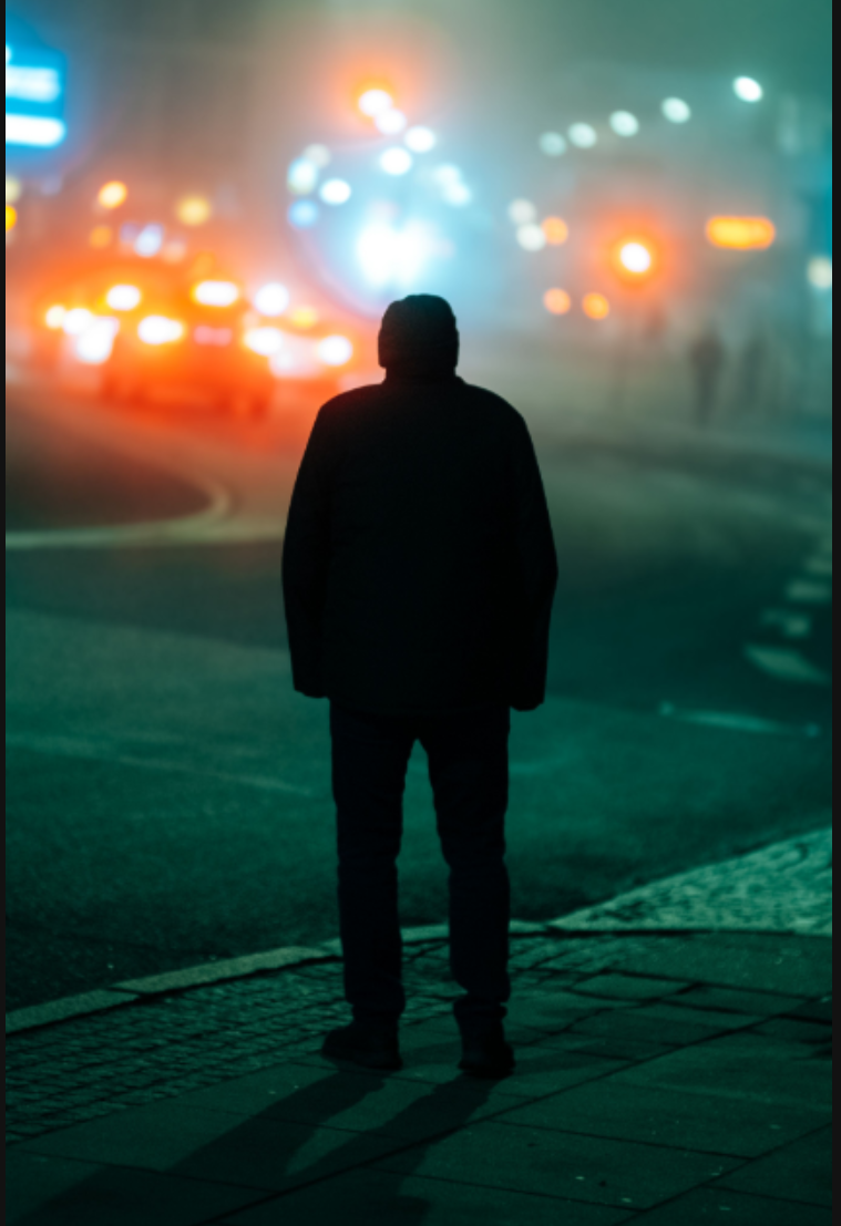 Man standing on a foggy street at night with car lights, sample from the Thypoch Simera 75mm f/1.4