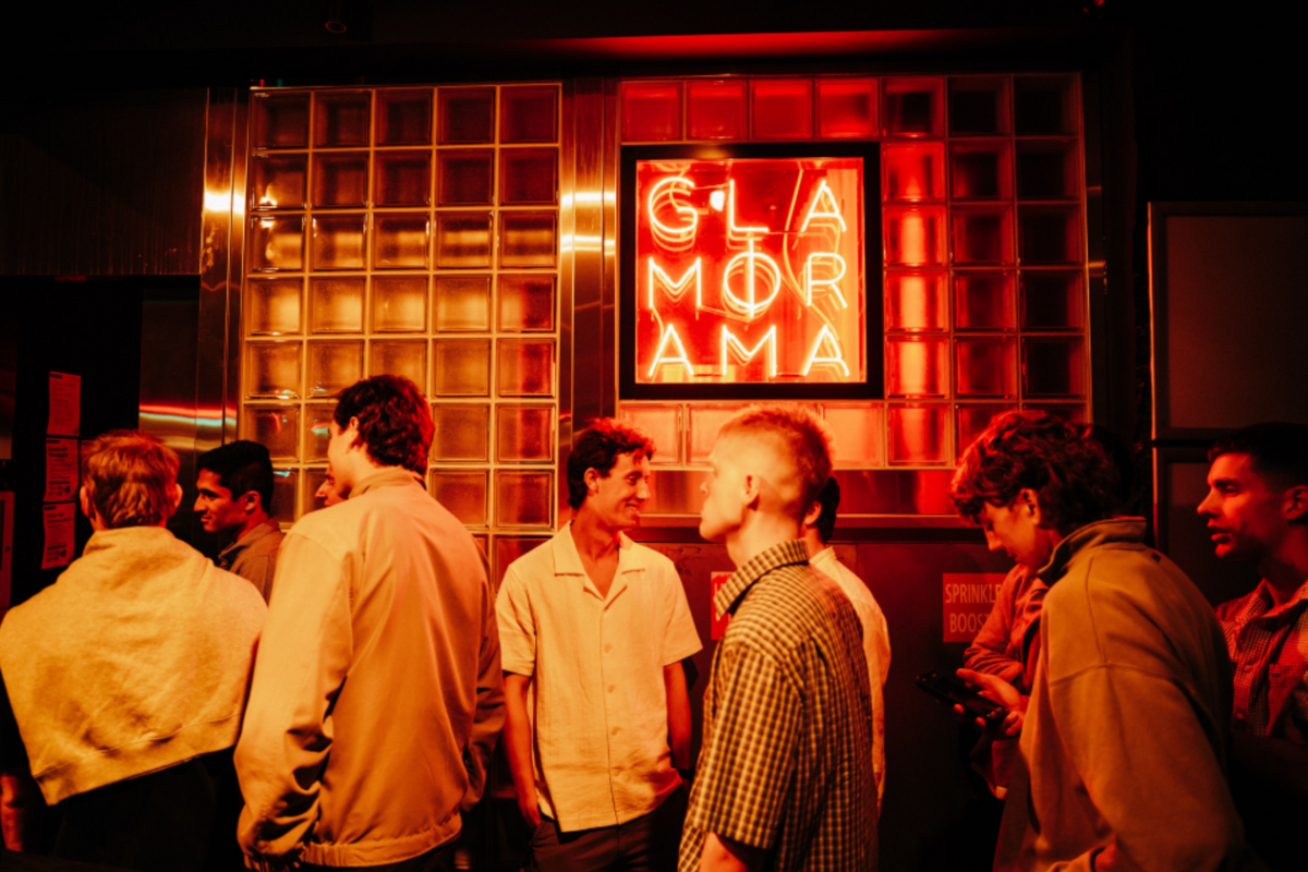 People outside a neon-lit bar at night, sample photo from the Thypoch Simera 21mm f/1.4