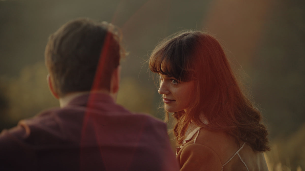Couple at golden hour with warm lens flare, sample still from the Thypoch Simera-C cine lens series