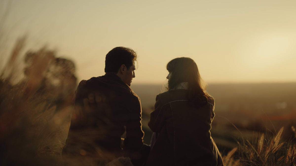 Couple silhouetted at sunset in tall grass, cinematic sample from the Thypoch Simera-C cine lenses