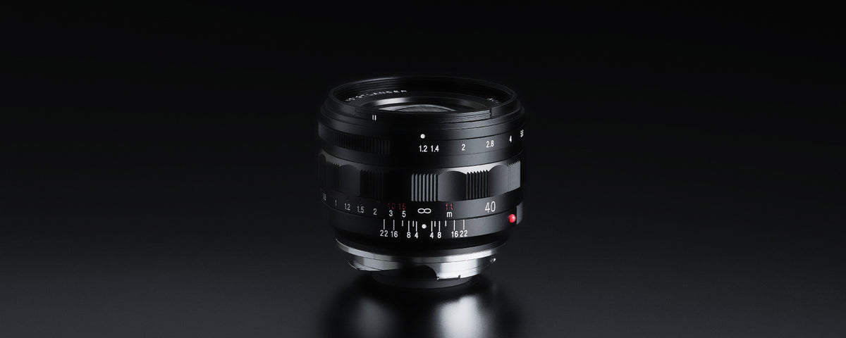 Voigtlander Nokton 40mm f/1.2 Leica M lens on black, side view with scales