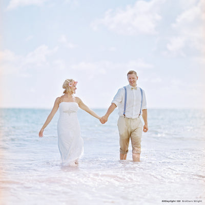 Bride and groom holding hands in the sea, sample shot on CineStill 50D 120