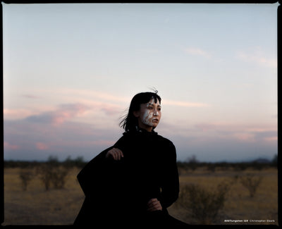 Woman in black in a desert at dusk, sample shot on CineStill 800T