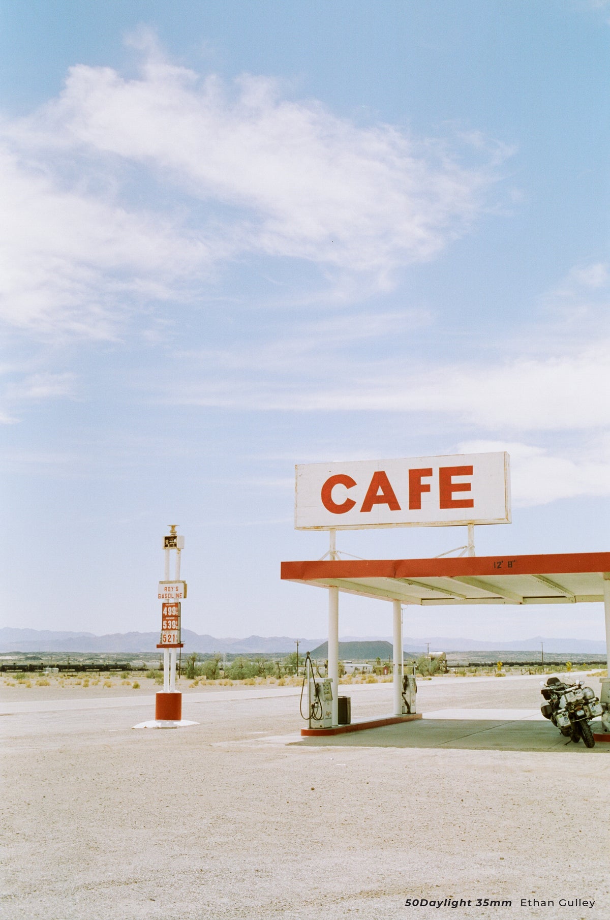 Desert cafe sign and fuel station under blue sky, sample shot on CineStill 50D