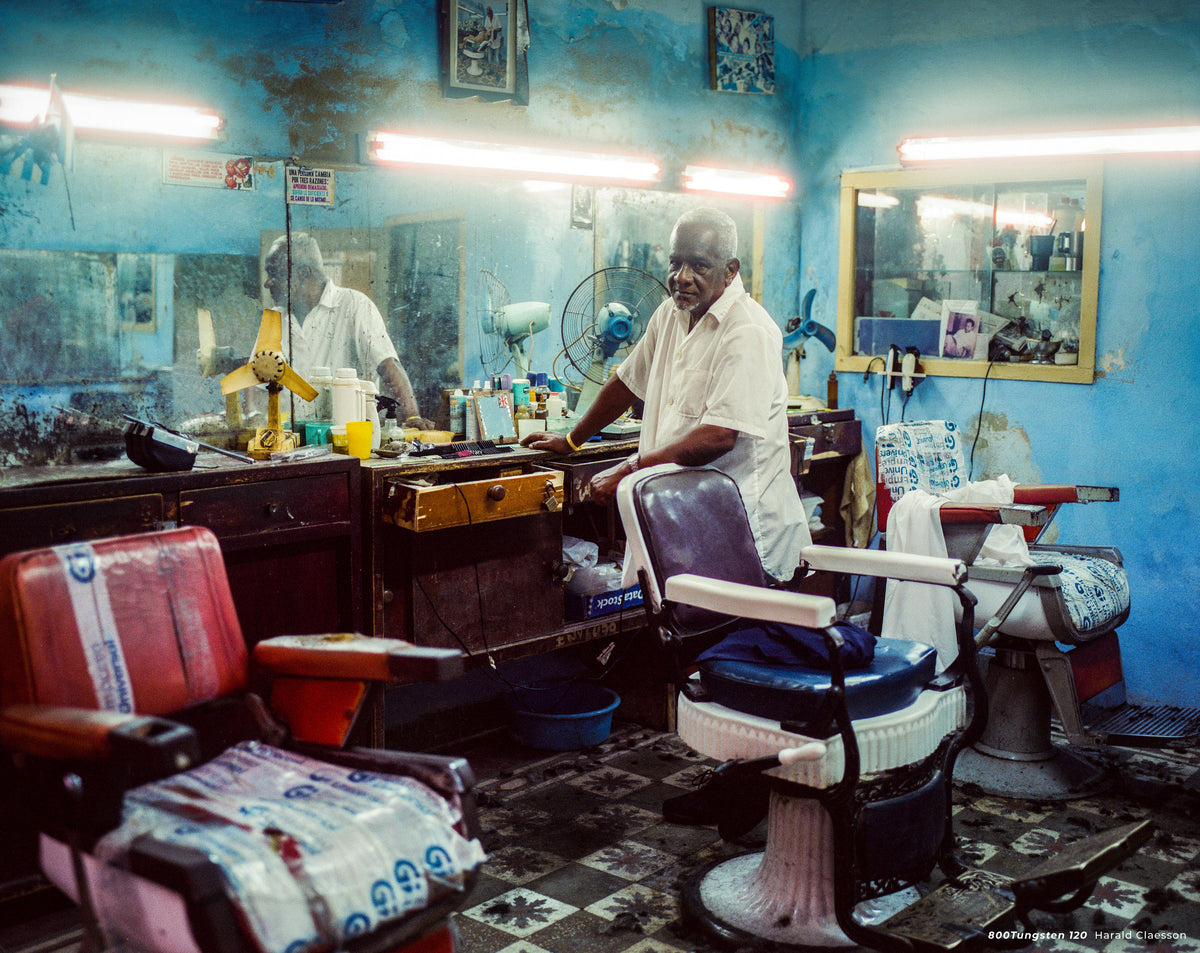 Barber in an old blue barbershop, sample shot on CineStill 800T