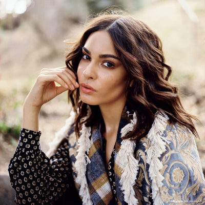 Portrait of a woman with wavy hair in a fringed shawl, sample shot on CineStill 50D 120