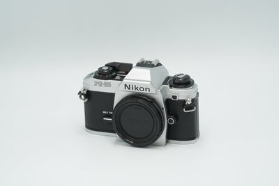 Nikon FG-20 silver 35mm film SLR camera body, front three-quarter view