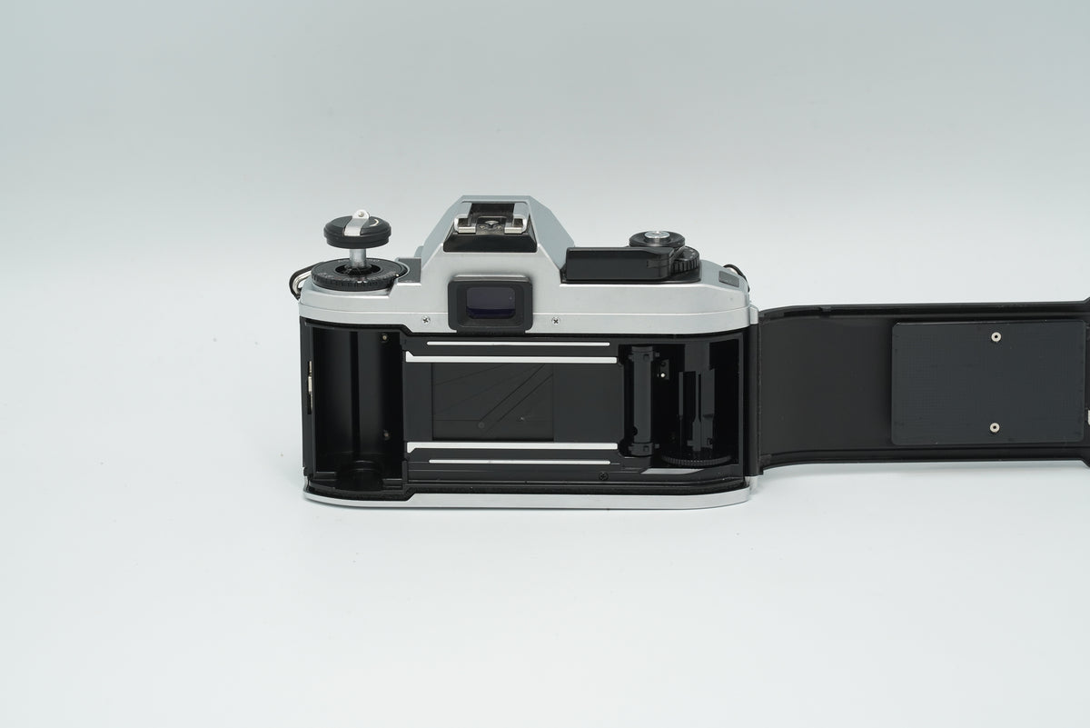 Nikon FG-20 silver with the back open, showing the film chamber