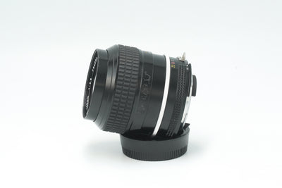 Nikkor 105mm f/2.5 Ai lens, side view on its rear cap