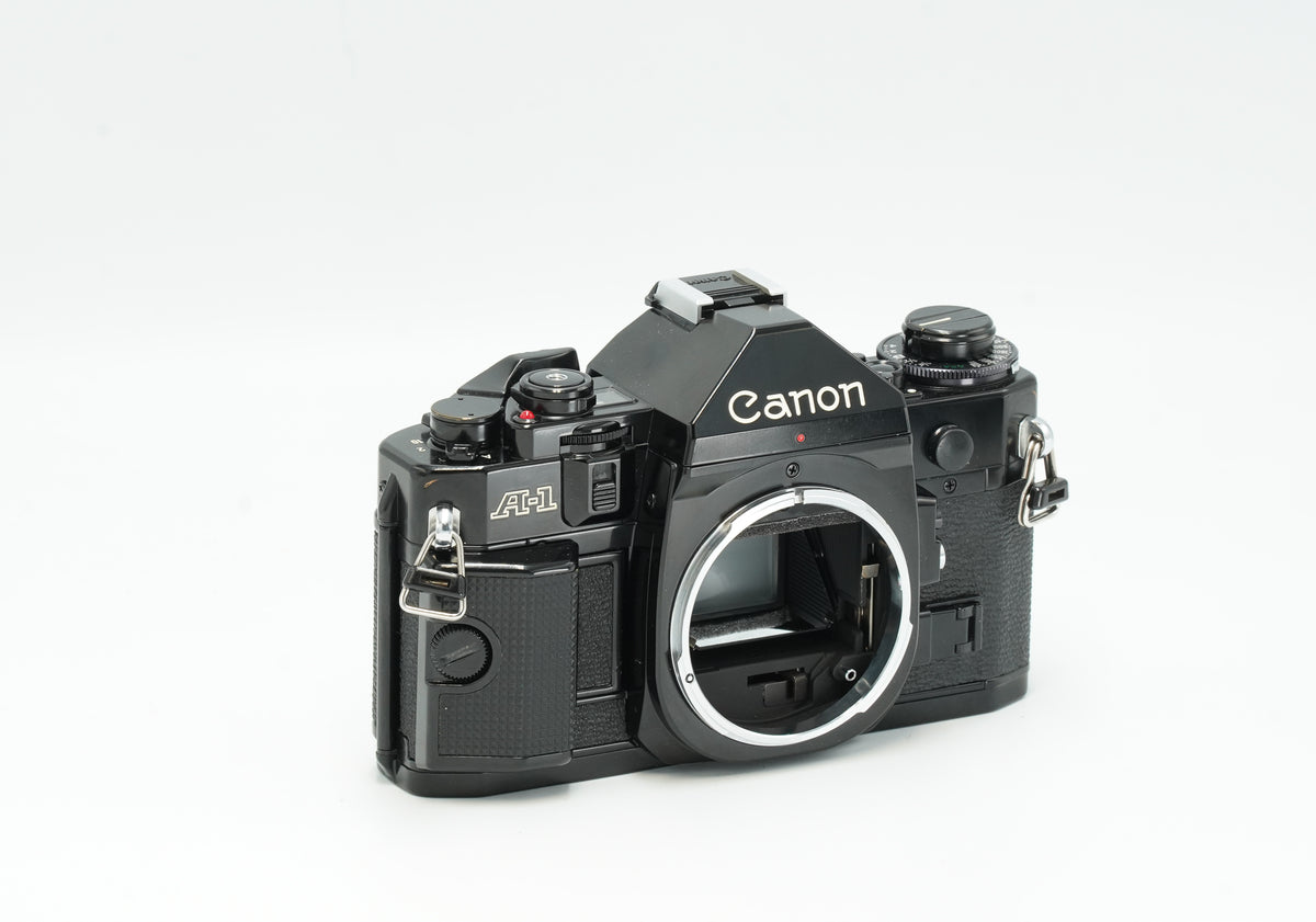 Canon A-1 black film camera, angled front view without lens