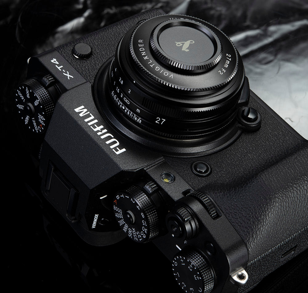 Voigtlander Ultron 27mm f/2 pancake on a black Fujifilm X-T4 with lens cap