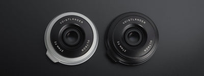 Voigtlander Ultron 27mm f/2 pancake lenses in silver and black, front view