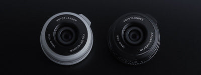 Voigtlander Color-Skopar 18mm f/2.8 pancake lenses in silver and black, front view