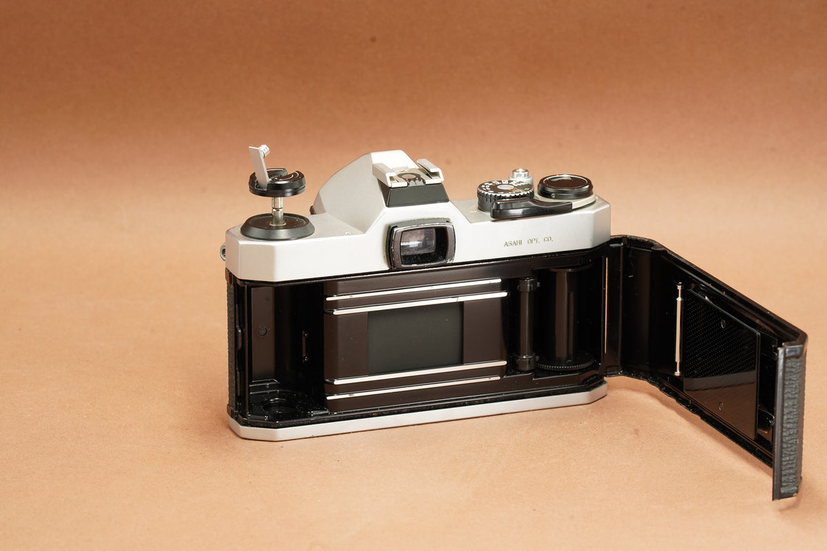 Pentax K1000 with the back open, showing the film chamber