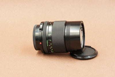 Canon nFD 135mm f/2.8 telephoto lens, side view with focus scale