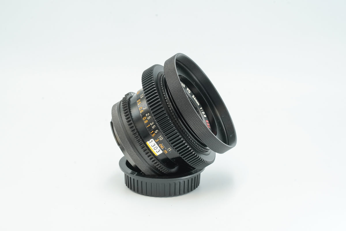 Canon FD 24mm f/2.8 cine-modded lens, side view with scales and hood