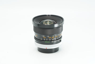 Canon FD 20mm f/2.8 S.S.C. wide-angle lens, side view with focus scale