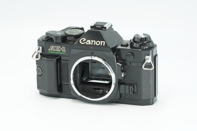 Canon AE-1 Program black 35mm SLR film camera body, front view