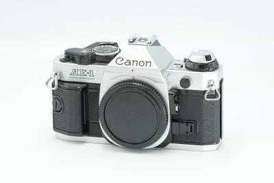 Canon AE-1 Program 35mm SLR film camera in silver, front view with body cap