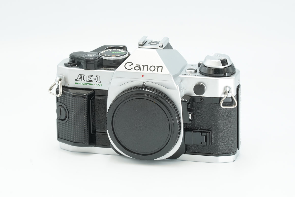 Canon AE-1 Program 35mm SLR film camera in silver, front view with body cap