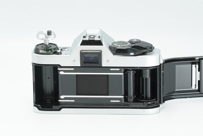 Canon AE-1 Program with the back open, showing the film chamber