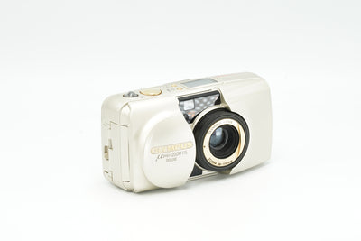 Olympus Mju Zoom 115 Deluxe 35mm point and shoot film camera in champagne, lens open