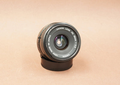 Canon New FD 35mm f/2.8 wide-angle lens, angled view of the front element
