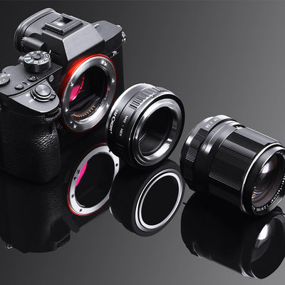 Sony A7 body, K&F Concept M42 to NEX adapter and Takumar lens on a black surface