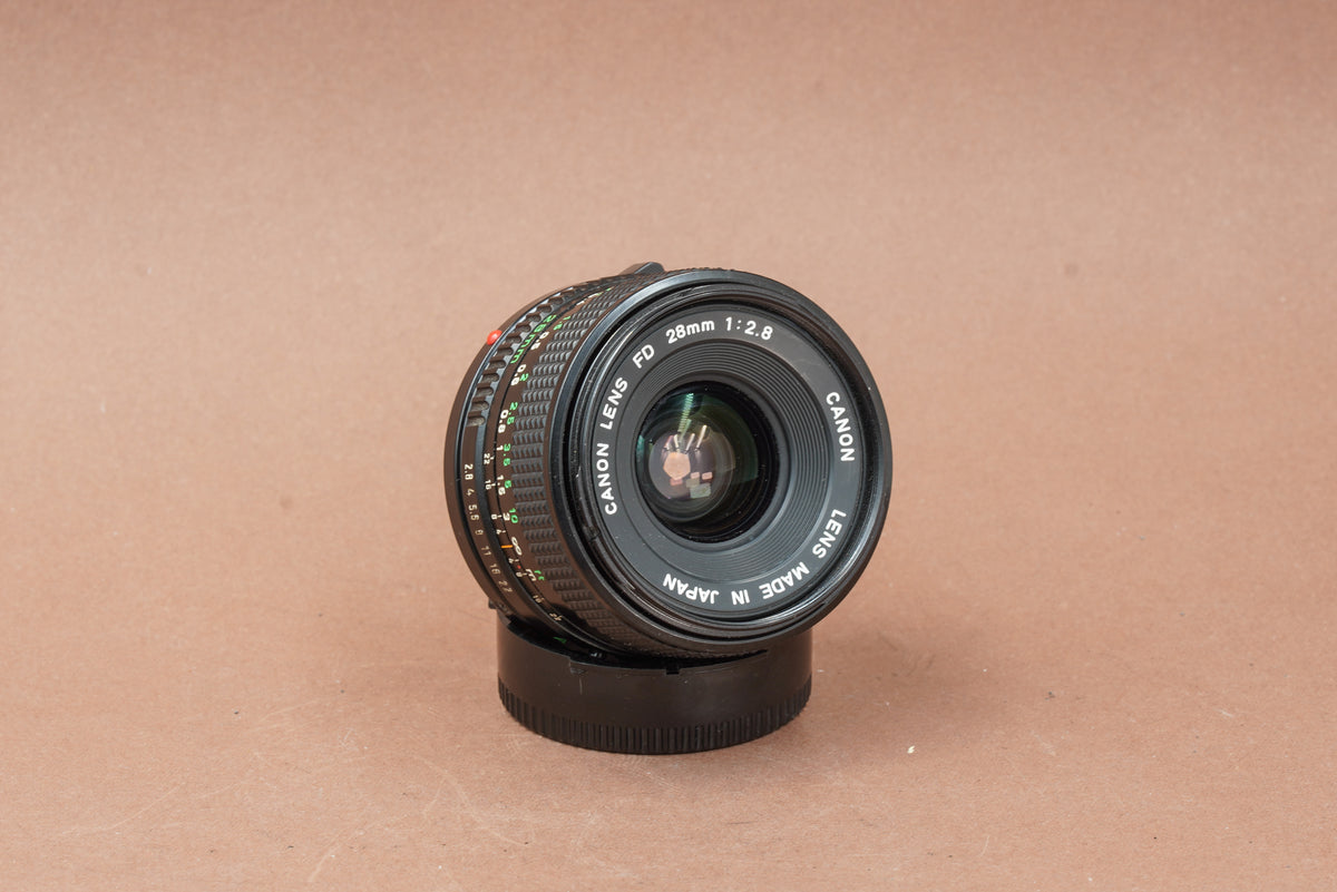 Canon New FD 28mm f/2.8 wide-angle lens, angled view of the front element