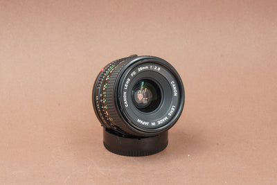 Canon New FD 28mm f/2.8 wide-angle lens, angled view of the front element
