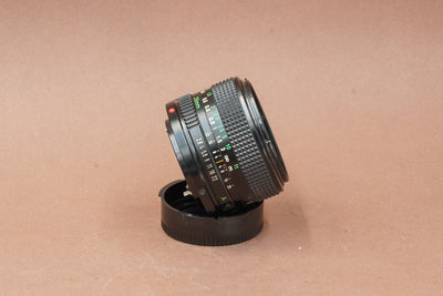 Canon nFD 28mm f/2.8, side view on its rear cap