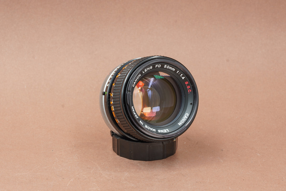 Canon FD 50mm f/1.4 S.S.C. standard lens, angled view of the front element