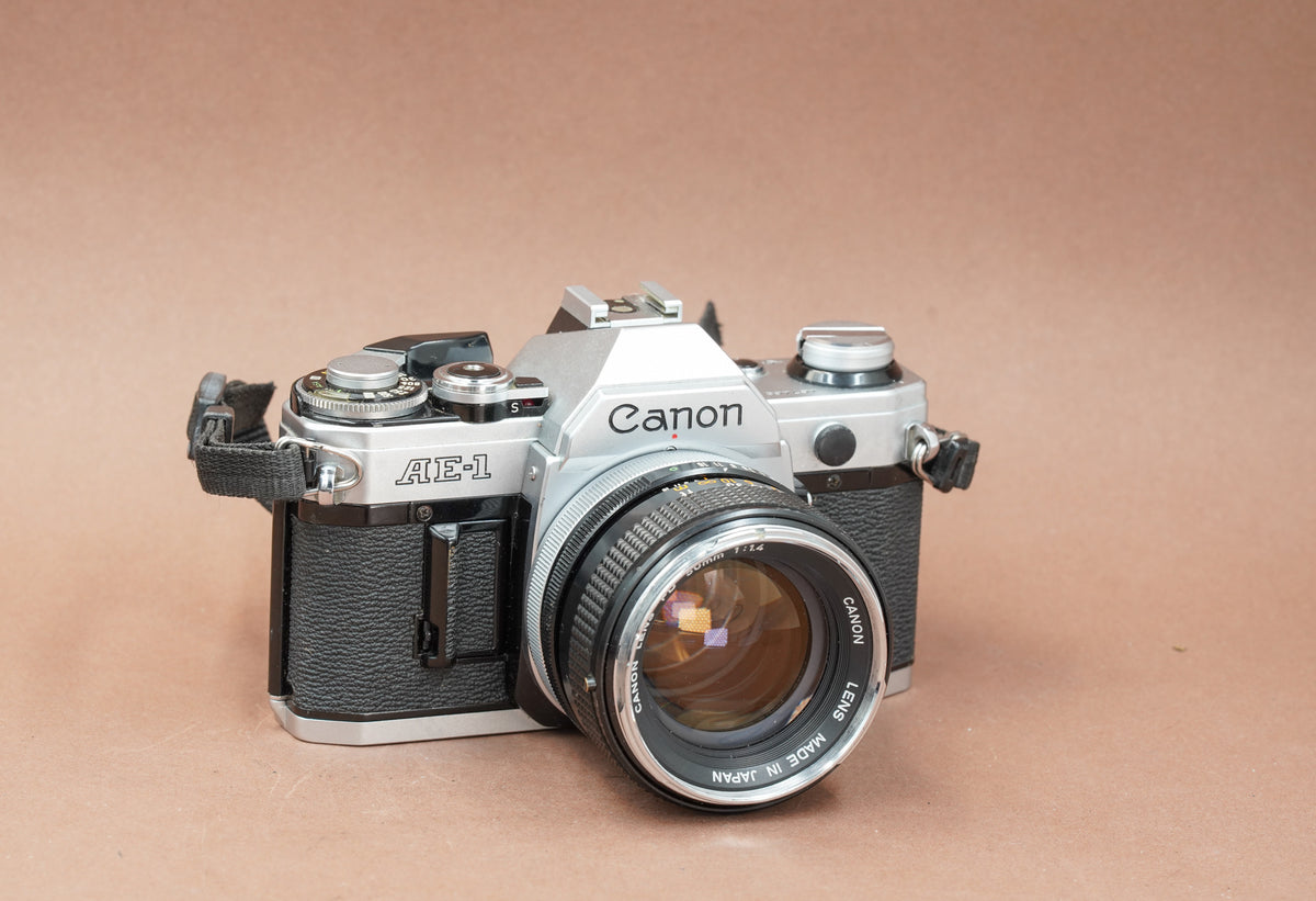 Canon AE-1 with Canon FD 50mm f/1.4 lens and strap