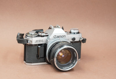 Canon AE-1 with Canon FD 50mm f/1.4 lens and strap