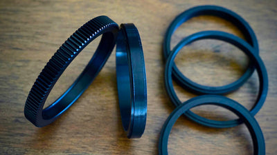 SIMMOD follow focus gear rings and spacers on a wooden table