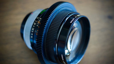 Canon lens fitted with a SIMMOD follow focus gear, close-up